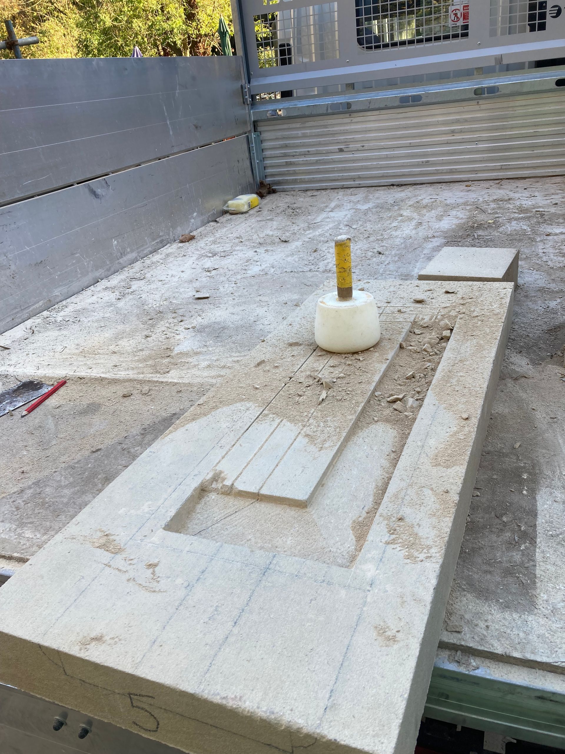 A piece of wood is sitting on top of a concrete surface.