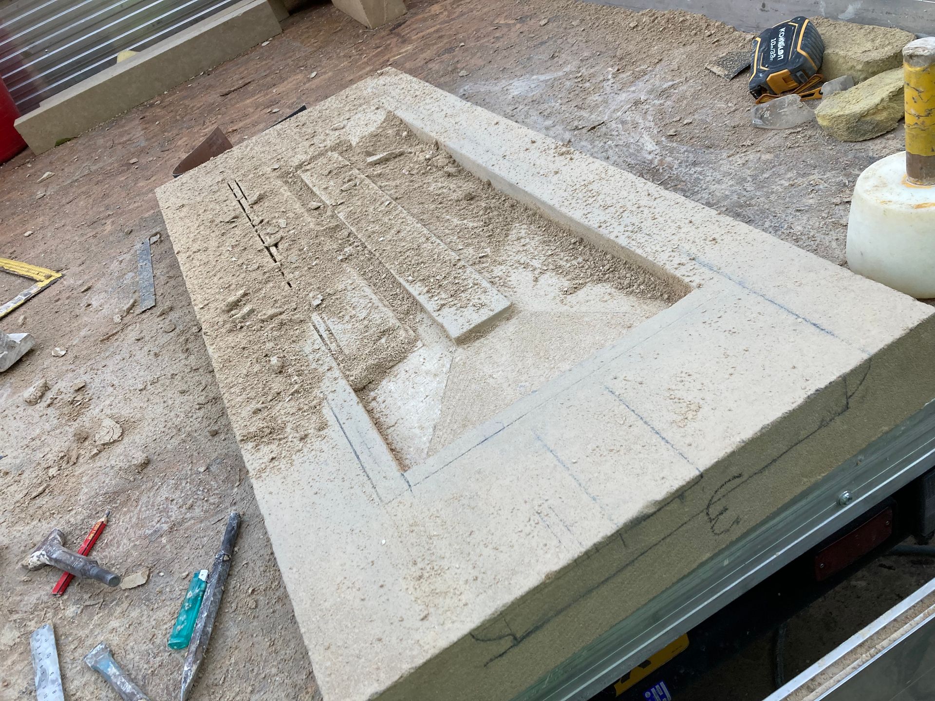 A piece of stone is sitting on top of a wooden table.
