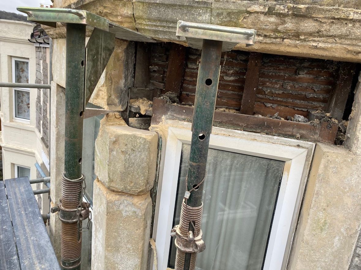A building with a window and scaffolding on it.