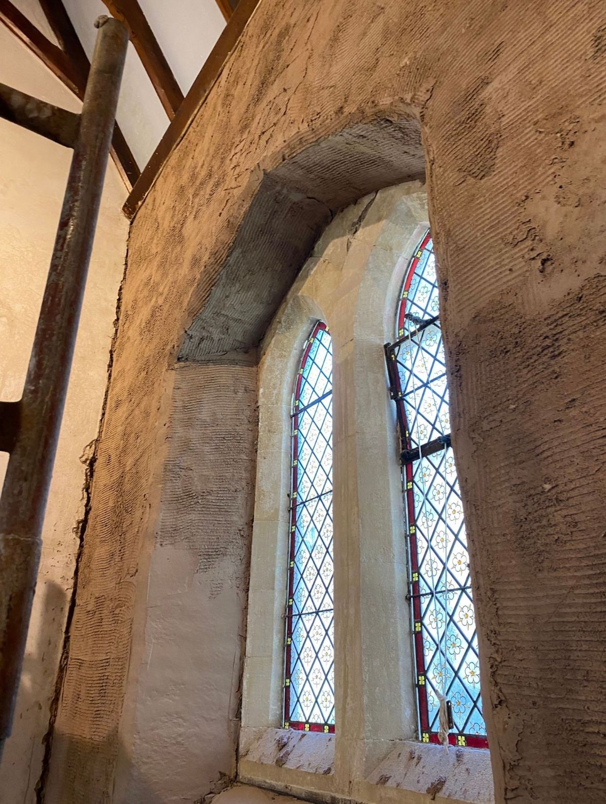 A stained glass window in a church is being restored.