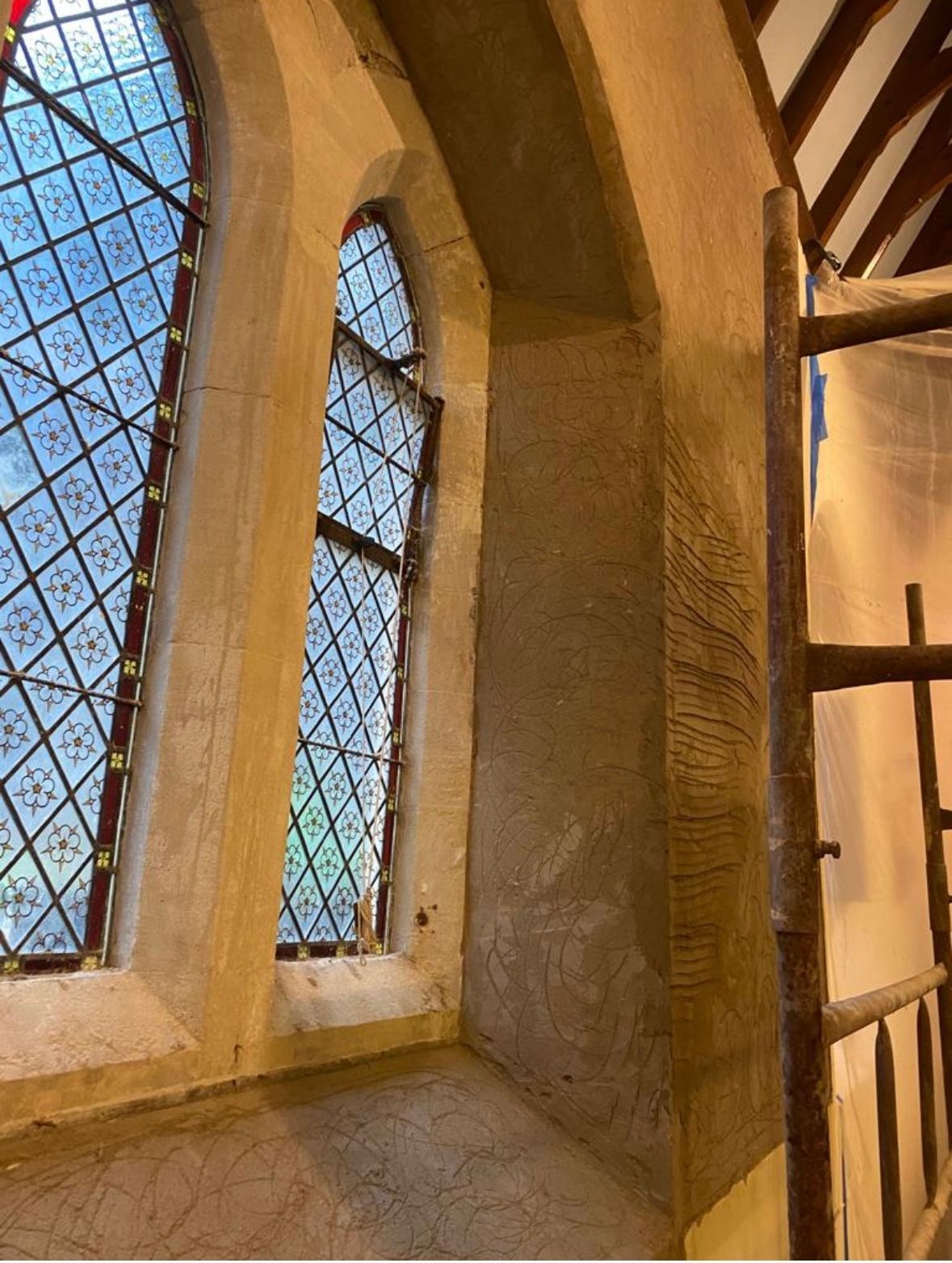 A window in a building with a scaffolding in front of it.