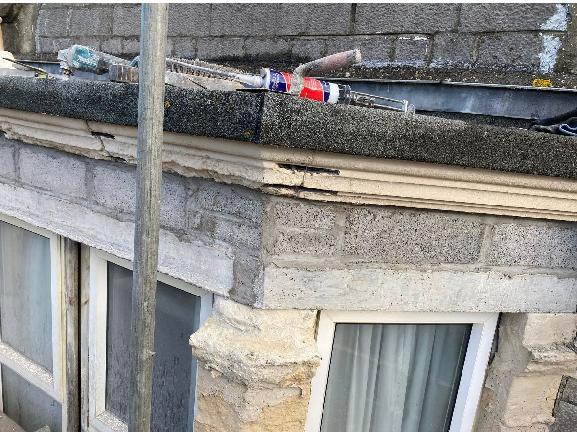 There is a bottle of toothpaste on the roof of a building.