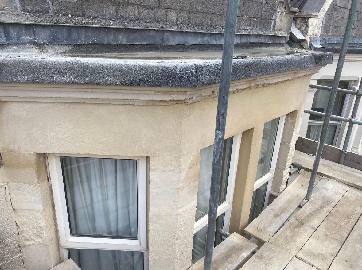 A window on the side of a building with scaffolding around it.