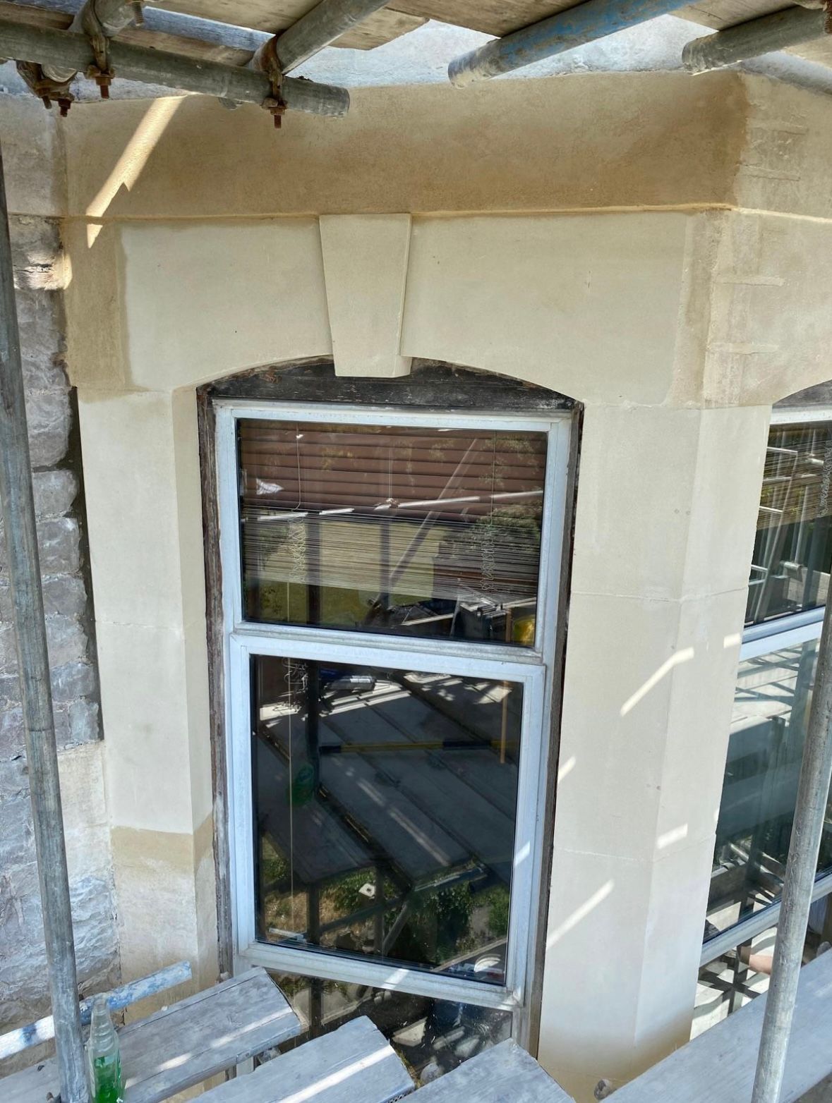 A window is being installed on the side of a building.