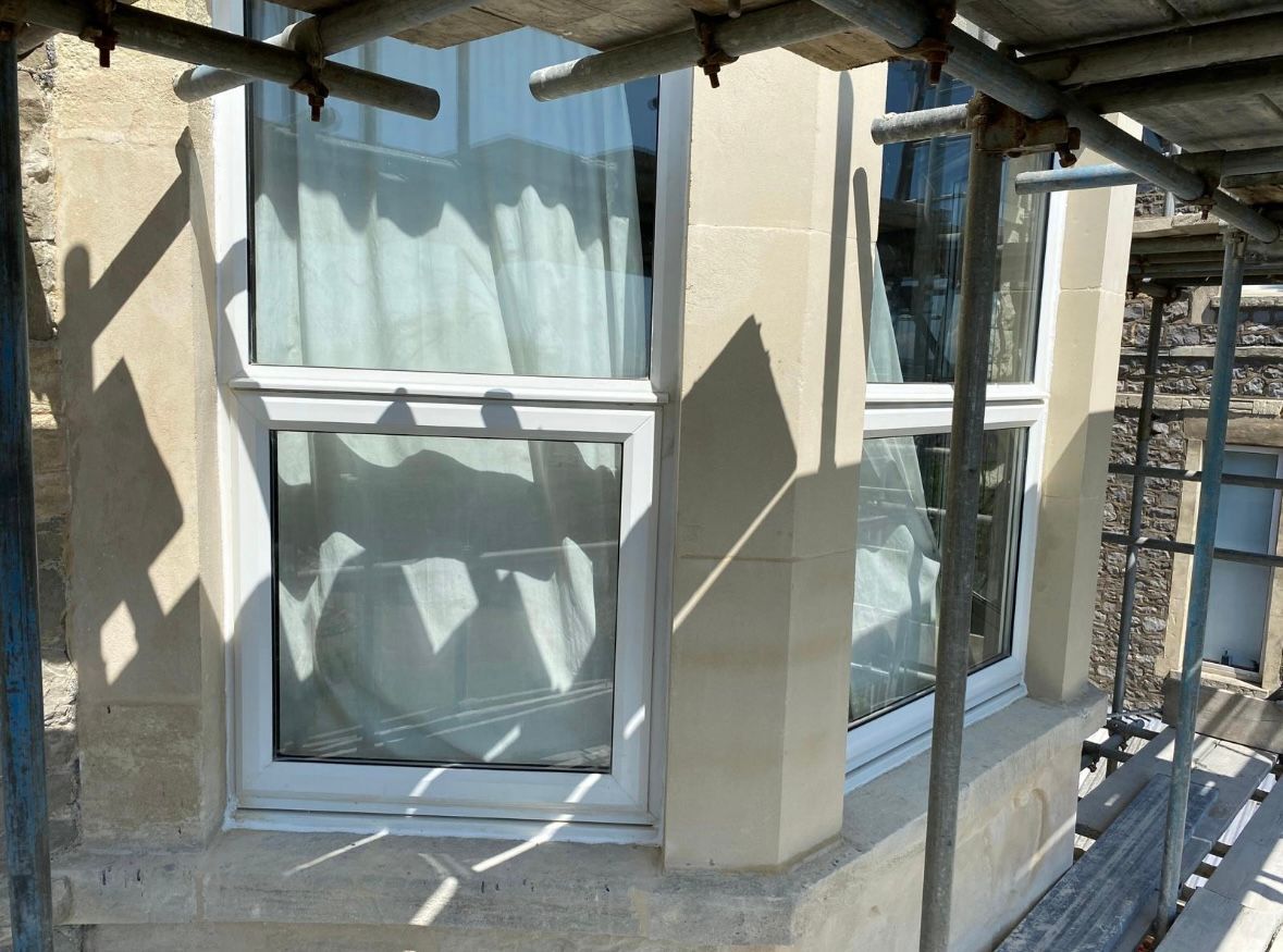 A window on a building with scaffolding around it