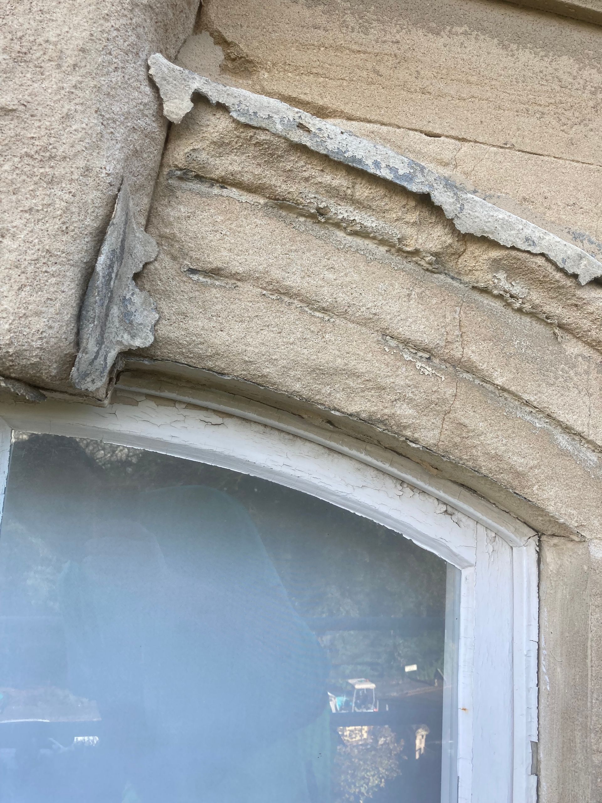 A close up of a window on a stone wall.