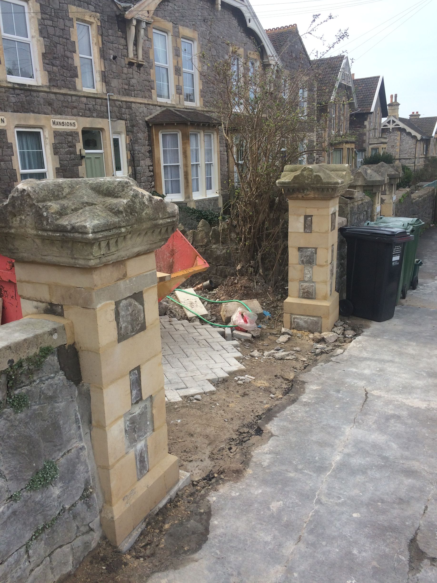 A row of houses are being built in a residential area.