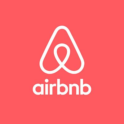 El logo de Airbnb está sobre un fondo rojo.