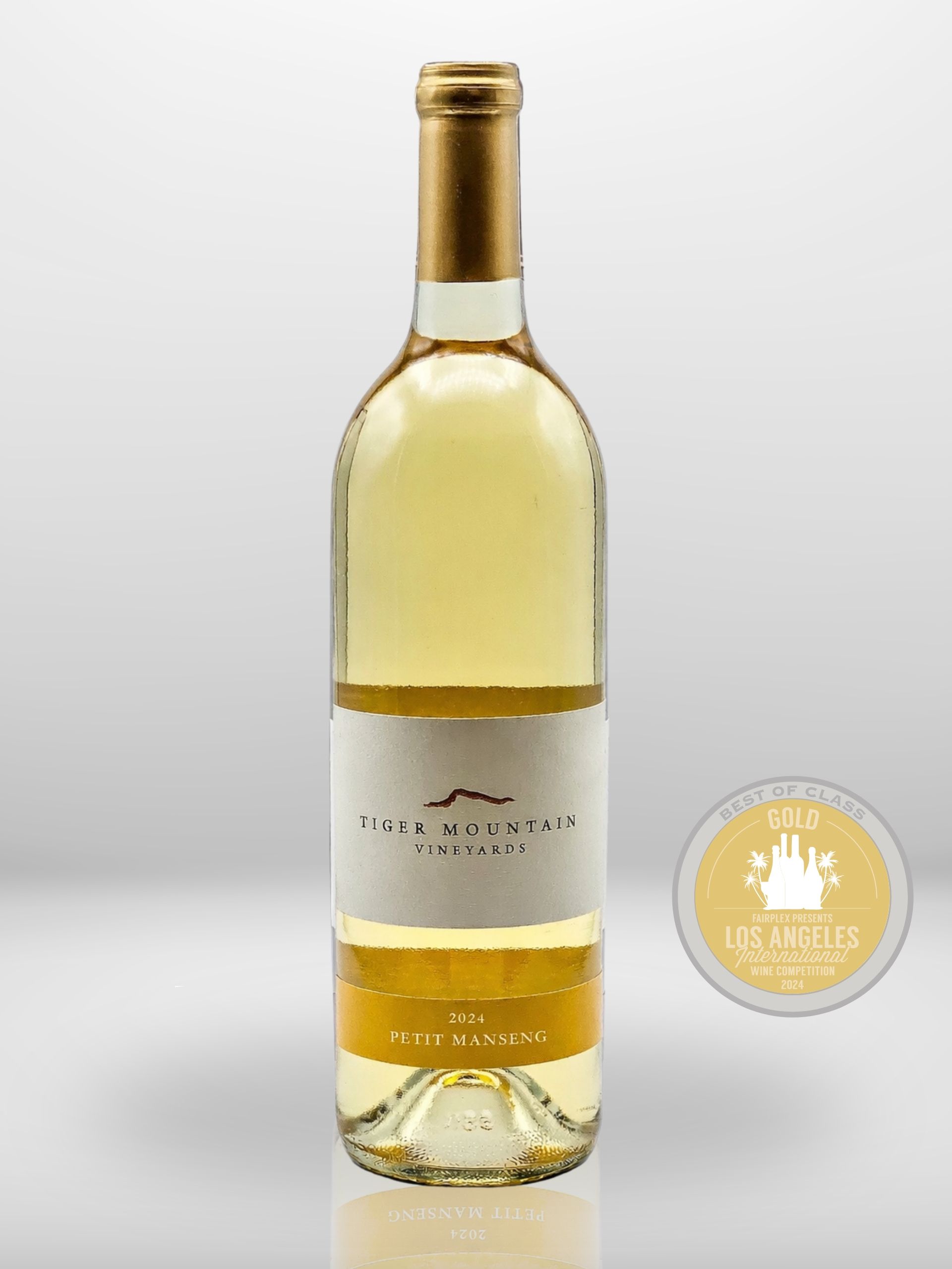 A bottle of white wine with a gold cap