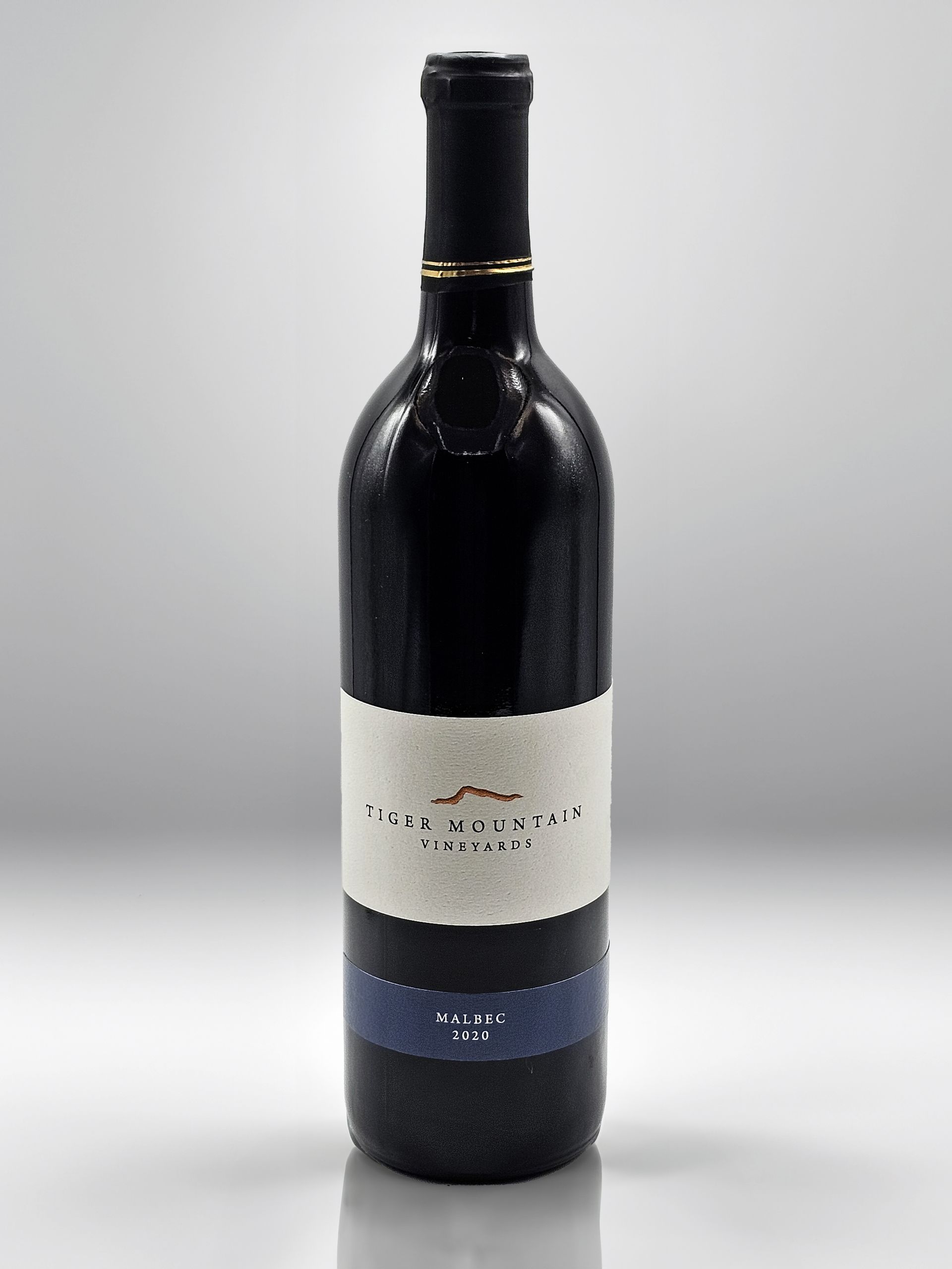 A bottle of wine with a white label on it