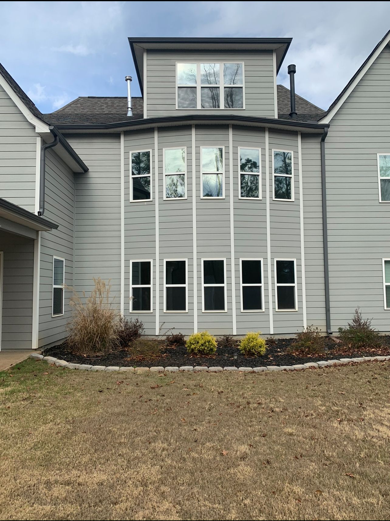 A large house with a lot of windows and a roof.