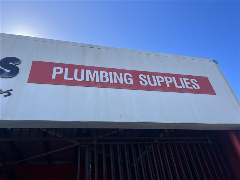 A sign that says plumbing supplies on it