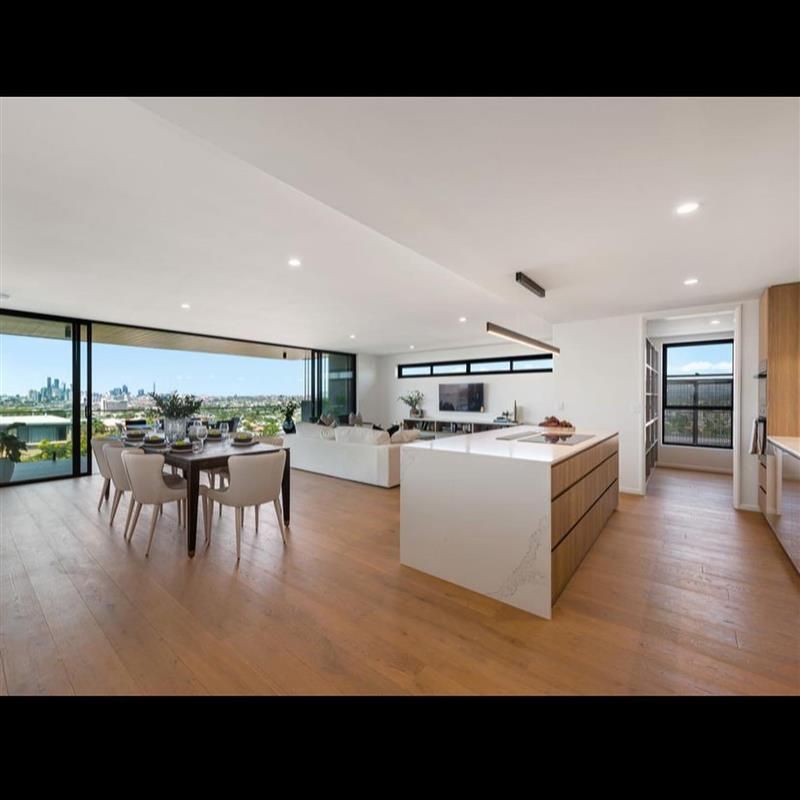 A large living room with a dining table and chairs
