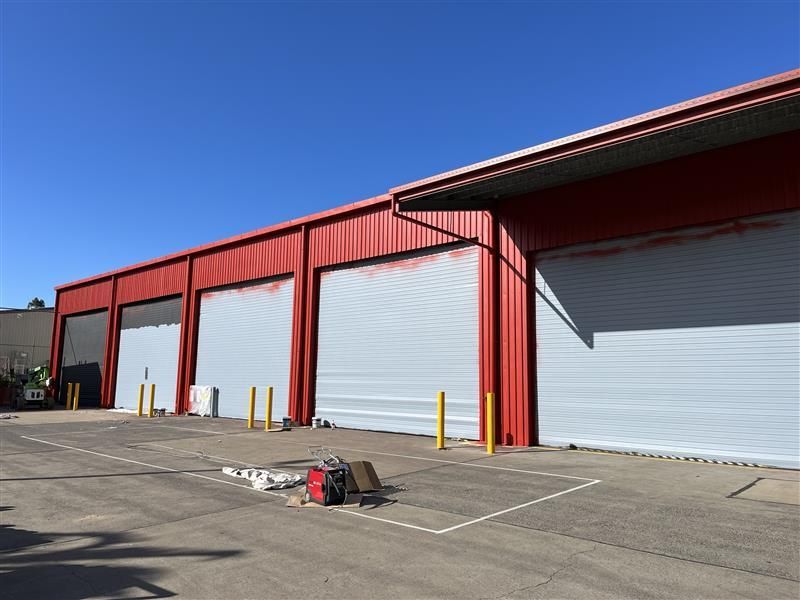 A red and white building with a lot of garage doors