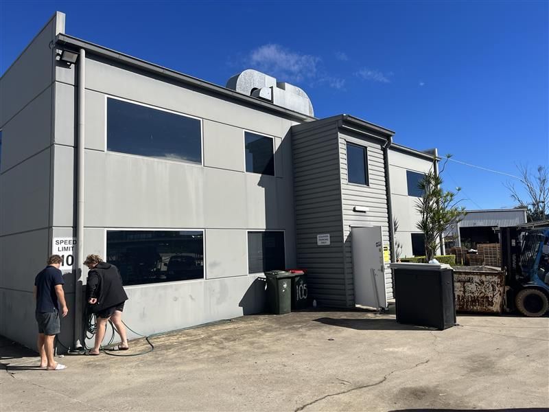 A group of people are standing outside of a large building.