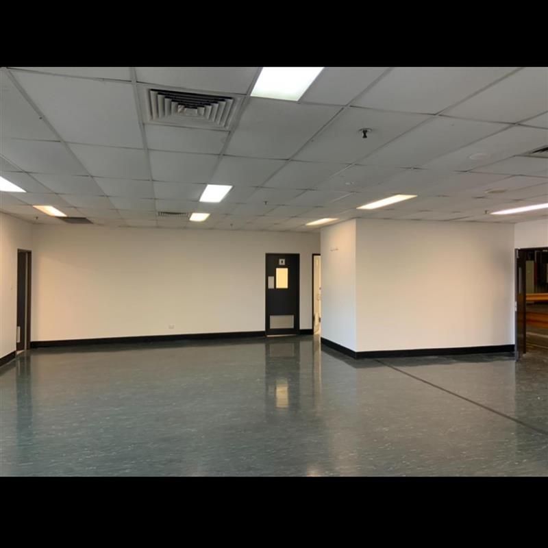 An empty room with white walls and a black door