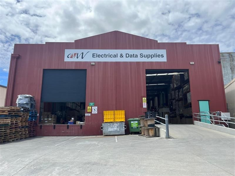 A large red building with a sign that says electrical & data supplies