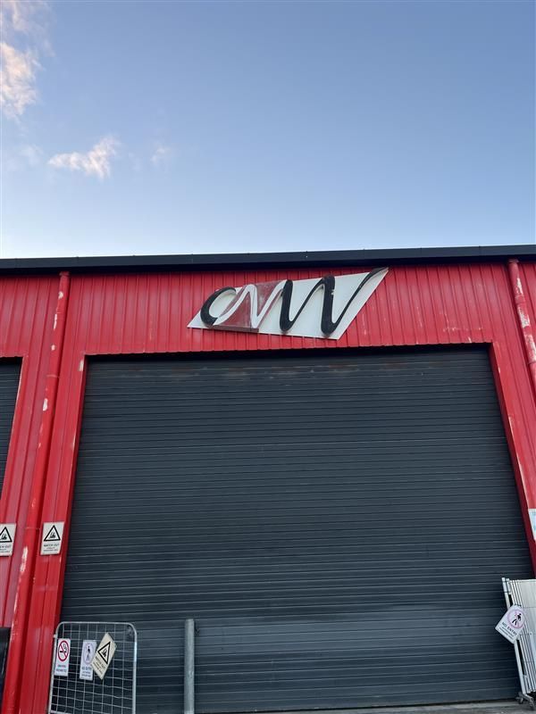 A red building with a sign that says cmv on it.