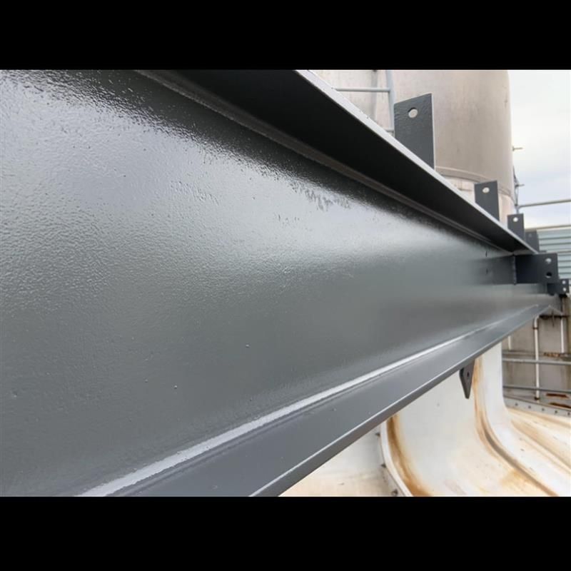 A close up of a gray metal beam on a building.