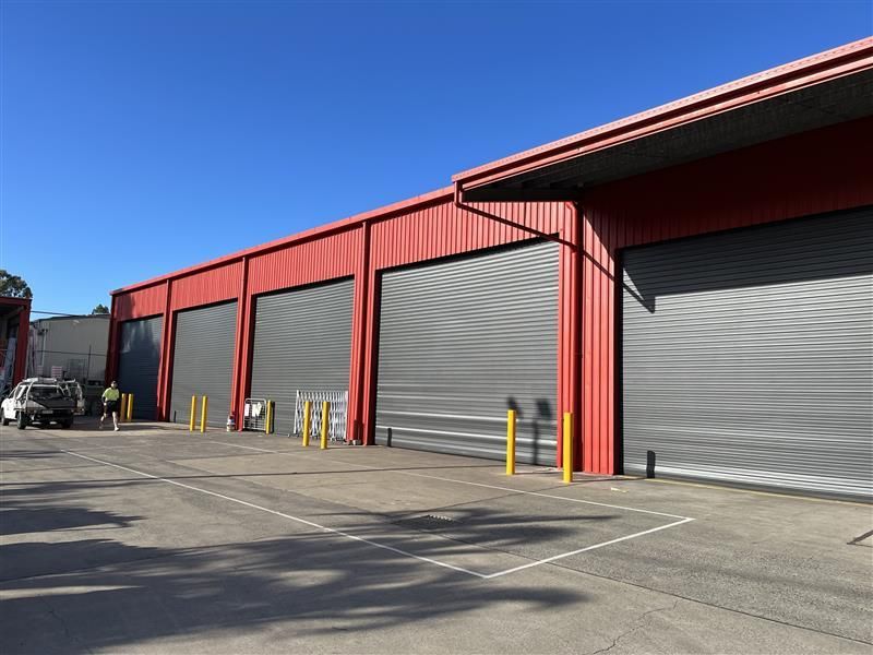 A red building with a lot of garage doors