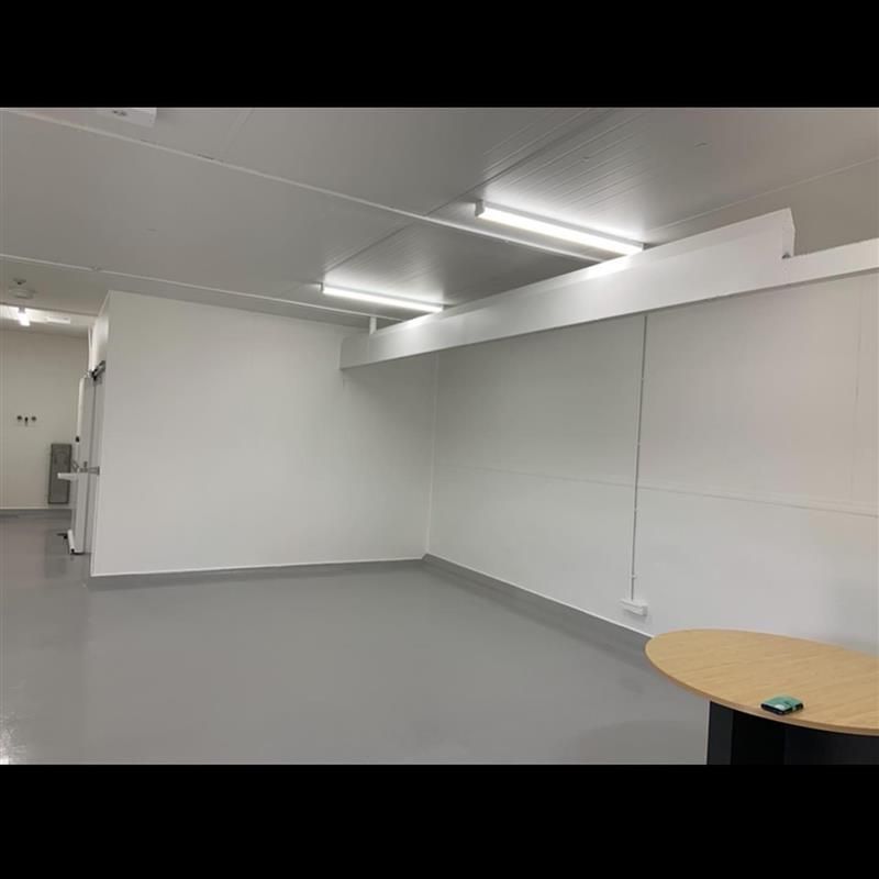 There is a table in the middle of the room.