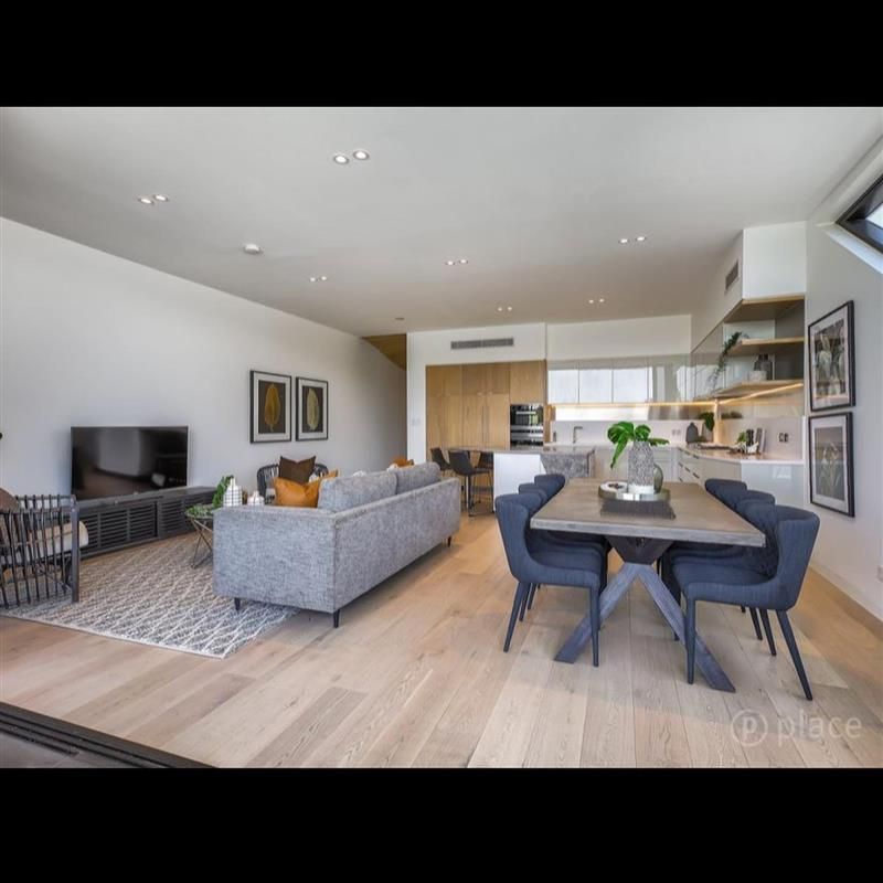 A living room with a couch a table and chairs