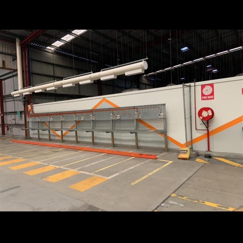 An empty parking lot with a fire hydrant on the side