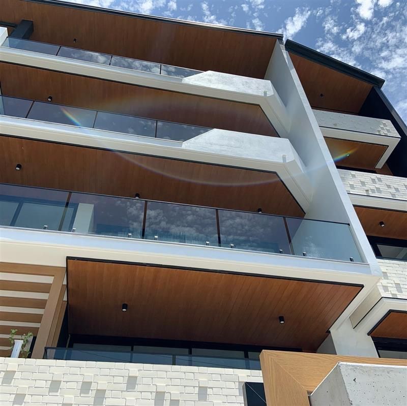 A building with a lot of balconies and a wooden ceiling