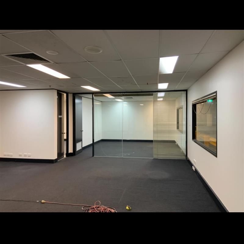 An empty office with a glass wall and a window