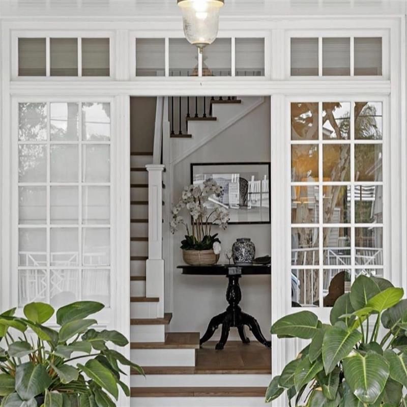 A staircase is visible through a sliding glass door