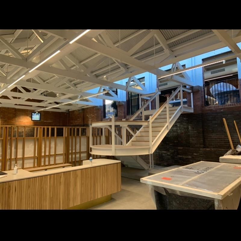 A building under construction with stairs and a wooden counter