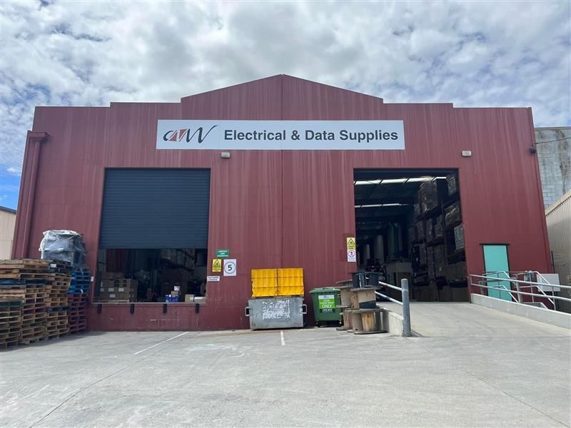 A large red building with a sign that says electrical and data supplies