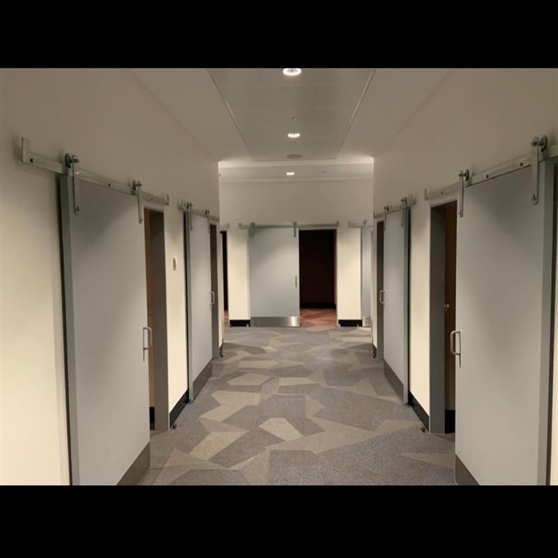 A long hallway with sliding doors and a patterned floor