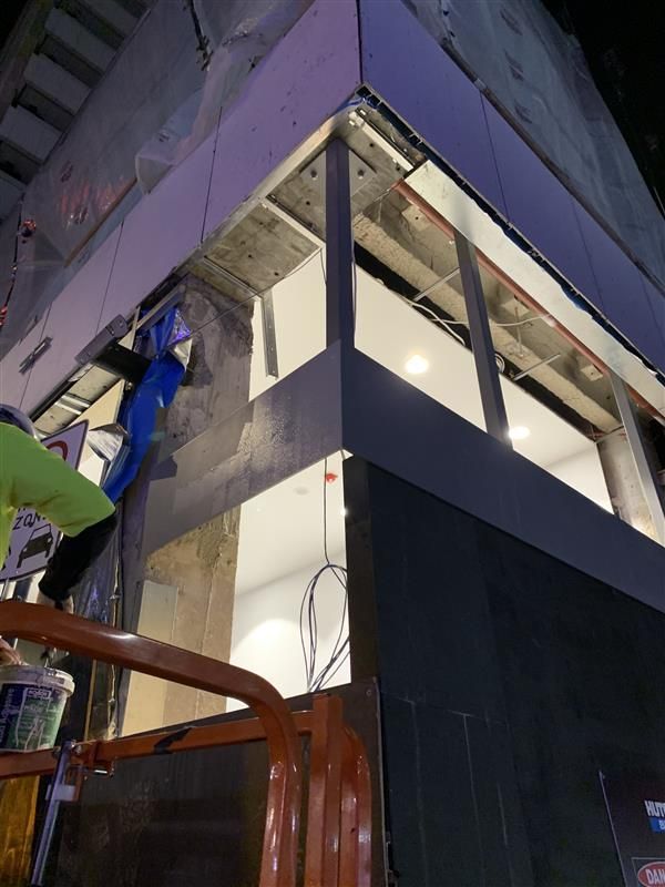 A building under construction with a purple roof