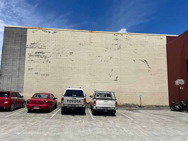 A toyota truck is parked in a parking lot in front of a building.