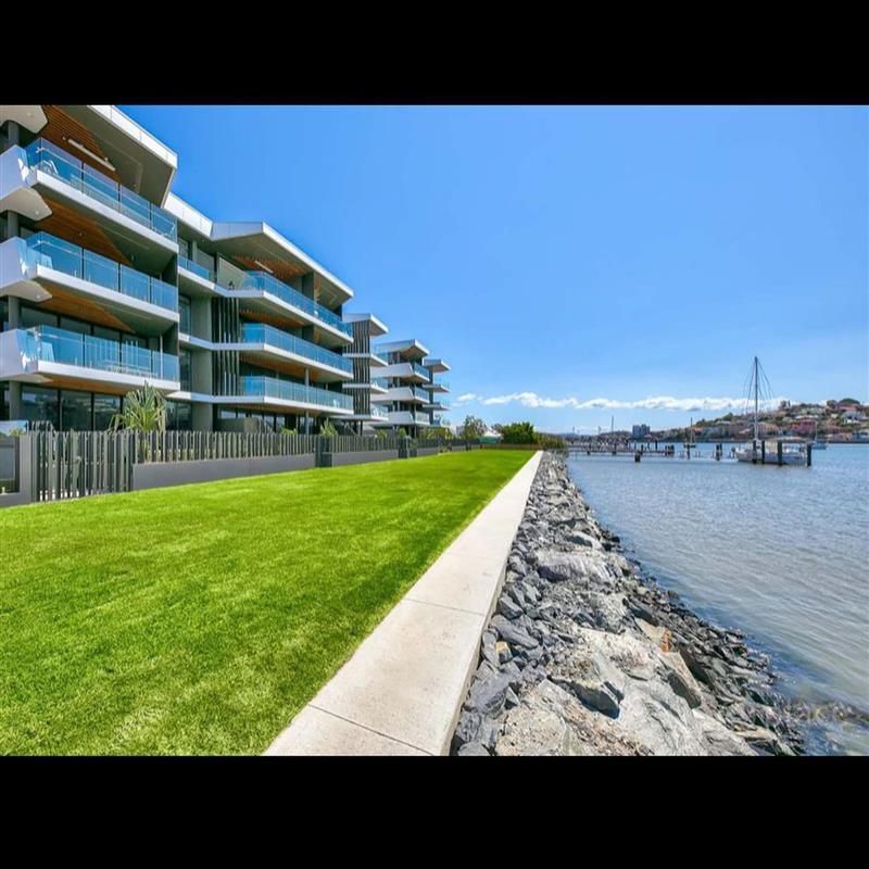 A row of buildings next to a body of water