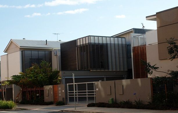 A row of houses with a gate in front of them