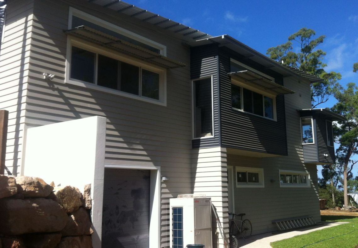 A house with a bicycle parked in front of it
