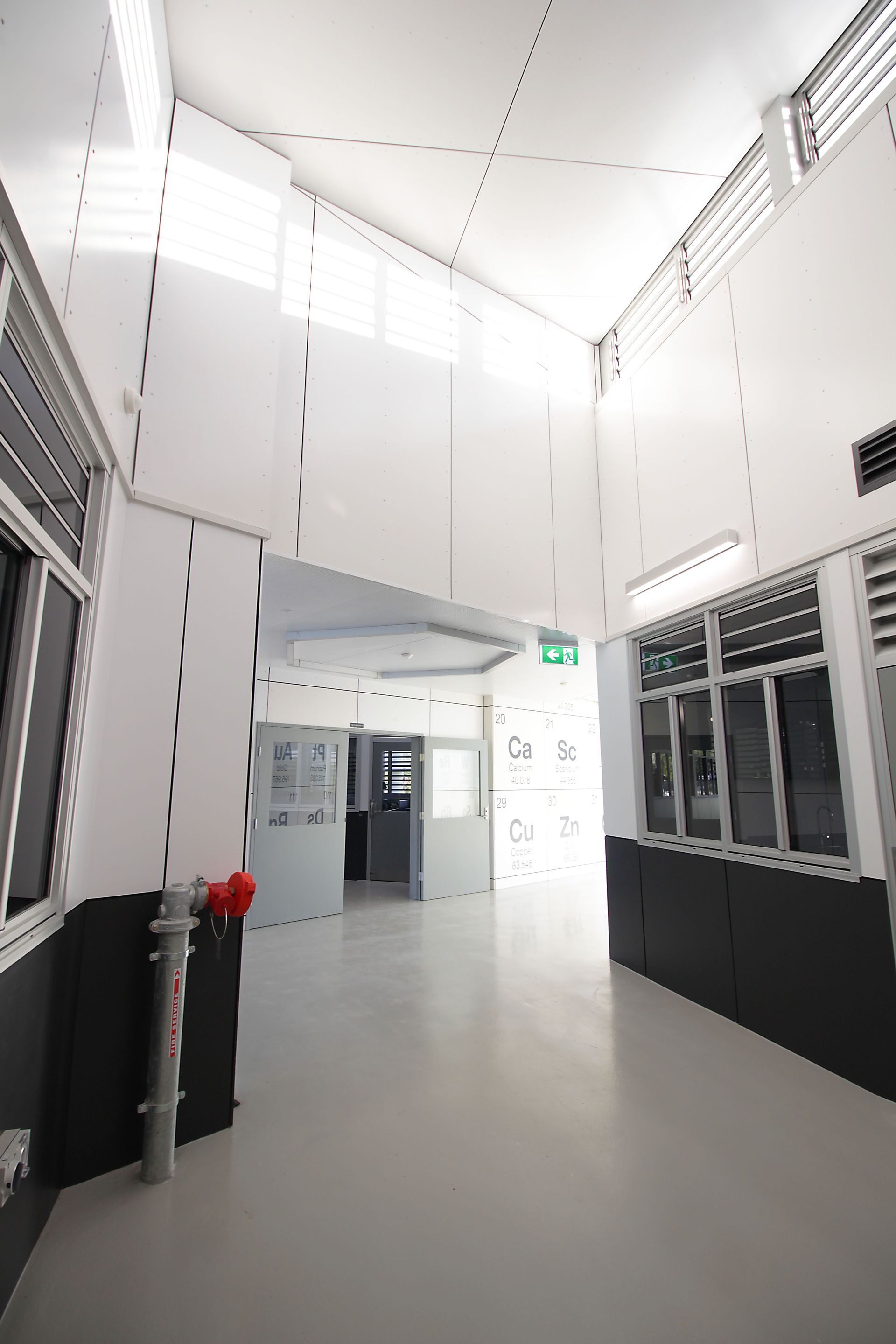 A long hallway with a fire hydrant in the middle of it