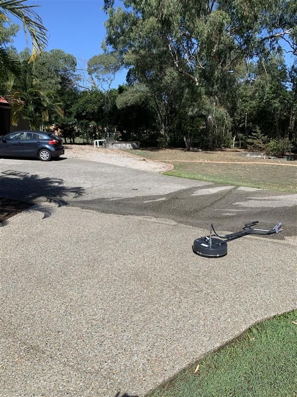 A metal detector is sitting on the side of the road next to a car.