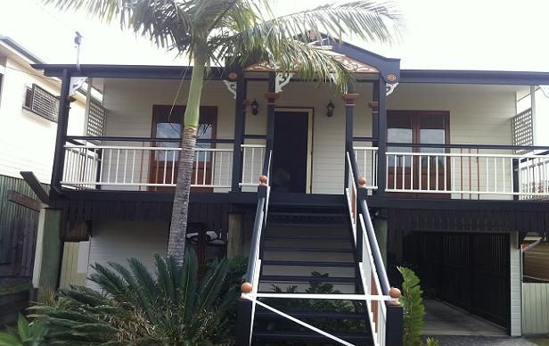 A house with a balcony and stairs leading up to it