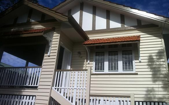 A house with a balcony and stairs leading up to it