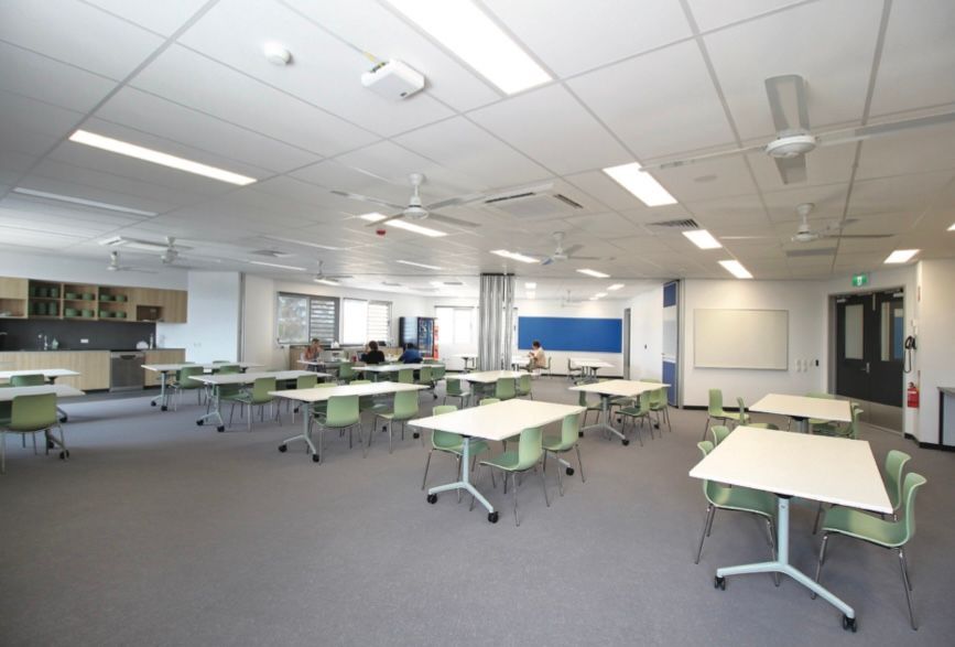 A large room with tables and chairs in it