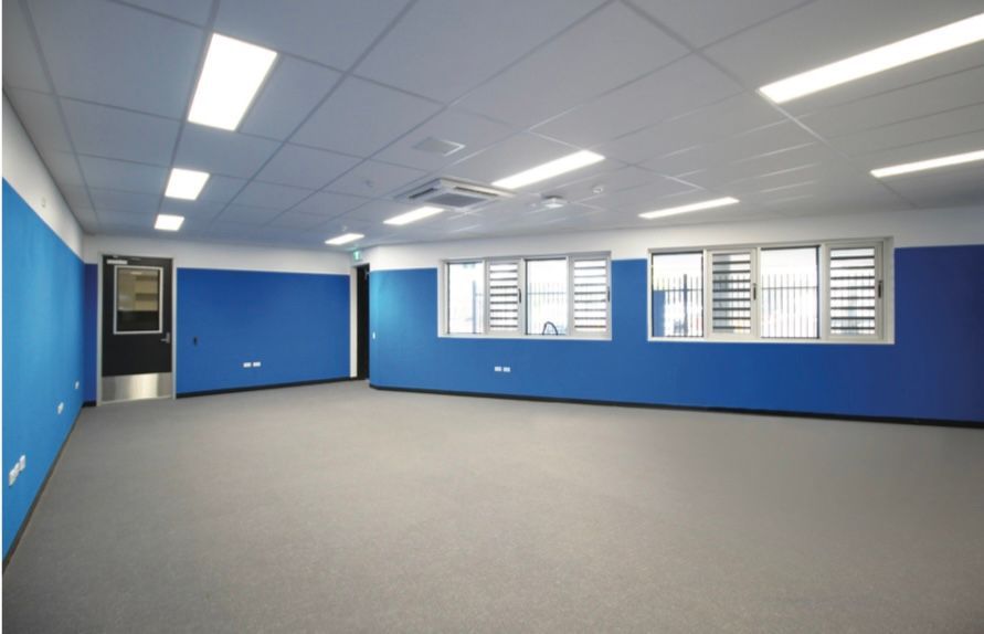 An empty room with blue walls and a door