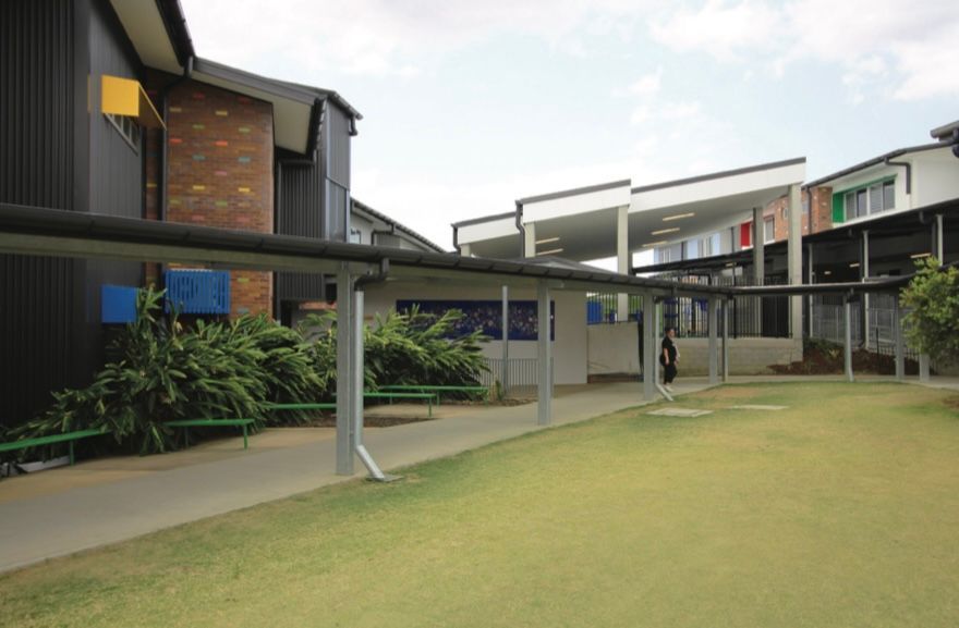 A row of buildings with a covered walkway between them