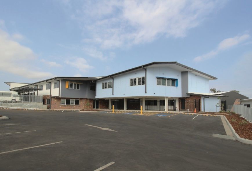 A large building with a parking lot in front of it