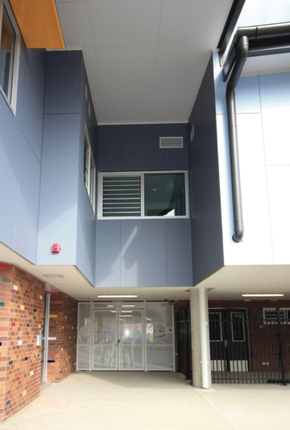 A building with a lot of windows and a brick wall