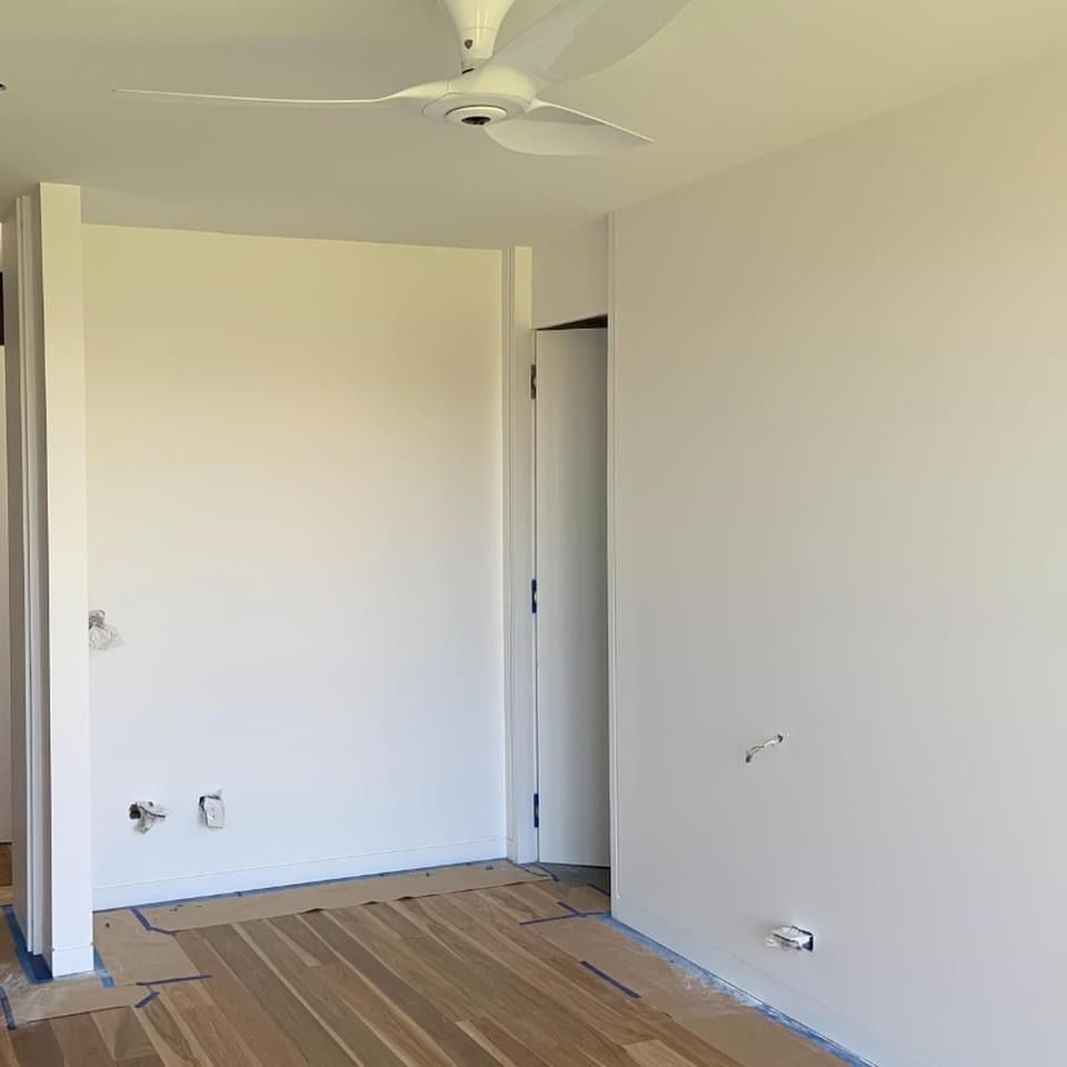 There is a ceiling fan in the corner of the room.