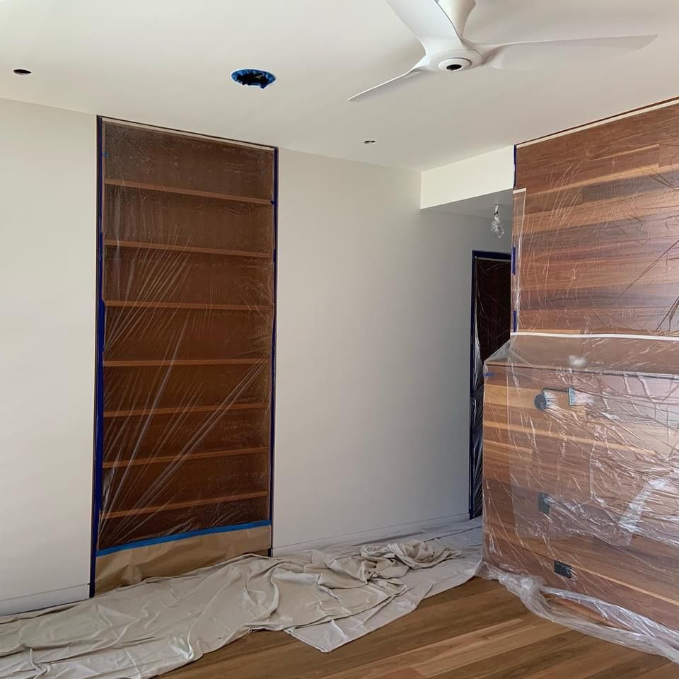 A room with wooden shelves and a ceiling fan