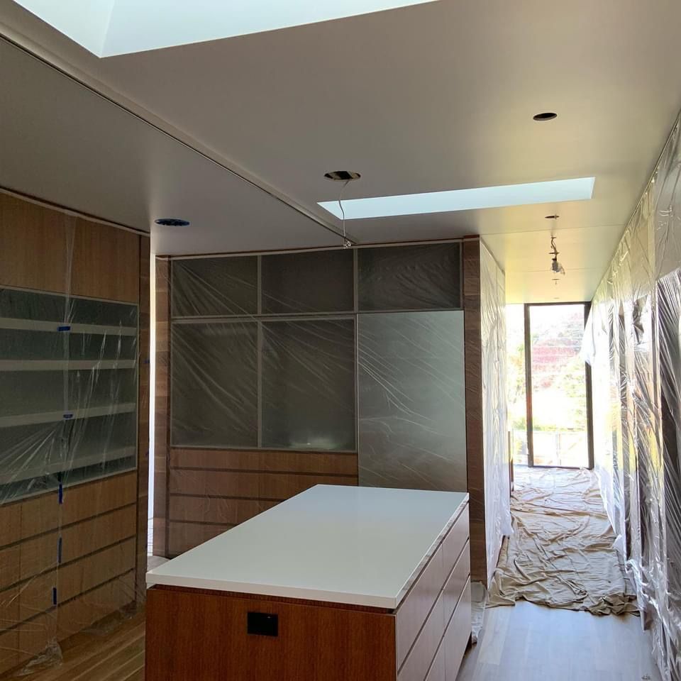 A long hallway with a large island in the middle